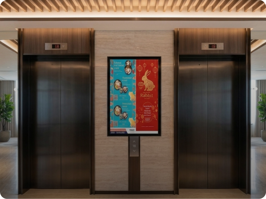Digital screen advertising between lift doors in a residential lobby